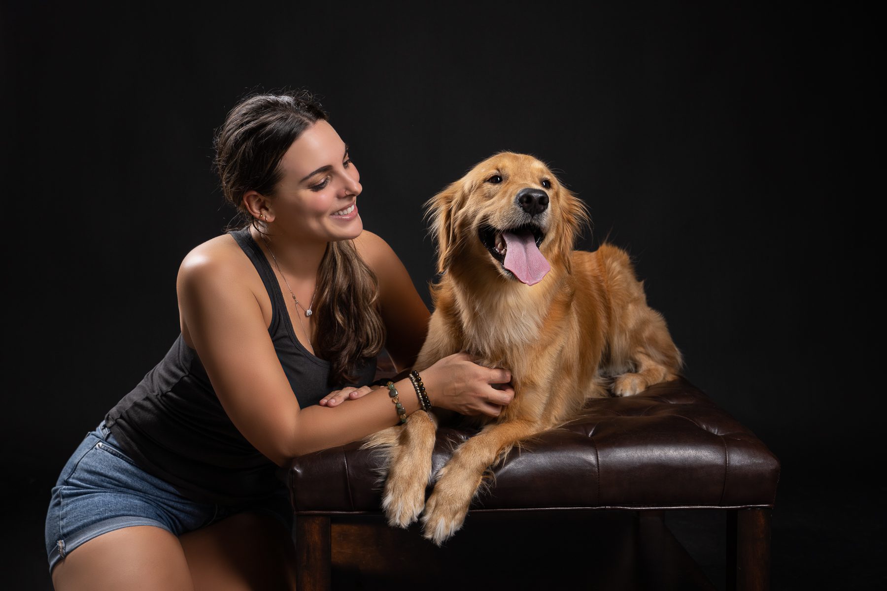 Smiling girl with dog on sofa